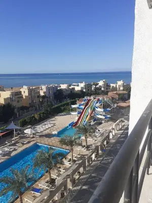a view of a resort with a pool and the ocean at Fanadir Bay Apartments in Hurghada