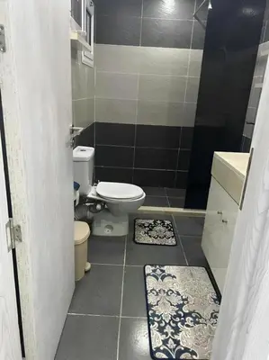 a small bathroom with a toilet and a sink at Fanadir Bay Apartments in Hurghada