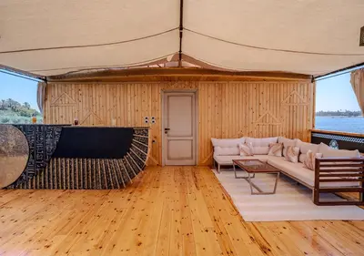 a living room with a couch and a table at Anoush Dahabiya 4 nights from Luxor to Aswan each Monday in Luxor