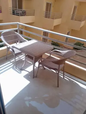 a table and two chairs on a balcony at Hurghada Apartment sea view Fiesta 209 in Hurghada