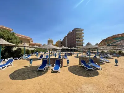 a bunch of chairs and umbrellas on a beach at Hurghada Apartment sea view Fiesta 209 in Hurghada