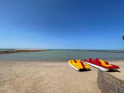 three boats sitting on a beach near the water at Hurghada Apartment sea view Fiesta 209 in Hurghada