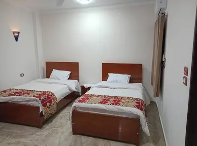 a room with two beds in a room at Maat Studio in Luxor