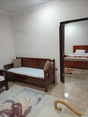 a bedroom with two beds and a mirror at Maat Studio in Luxor