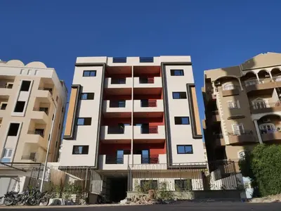 two tall apartment buildings next to each other at مبارك 5 in Hurghada