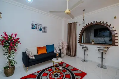 a living room with a couch and a table at Madares sweet home appartment in Hurghada