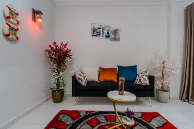 a living room with a couch and a table at Madares sweet home appartment in Hurghada