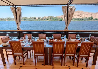 a dining room with a table and chairs on a boat at Anoush Dahabiya 7 nights from Luxor to Luxor each Monday in Luxor