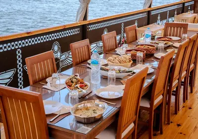 a long table on a boat with food on it at Anoush Dahabiya 7 nights from Luxor to Luxor each Monday in Luxor