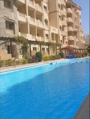a large blue swimming pool in front of a building at Florenza khamsin Resort Hurghada Red Sea in Hurghada