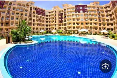 a large swimming pool in front of a large building at Florenza khamsin Resort Hurghada Red Sea in Hurghada