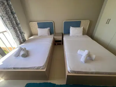 two beds in a room with towels on them at Tawila 3BR Family Townhouse • Lagoon Retreat Villa in Hurghada
