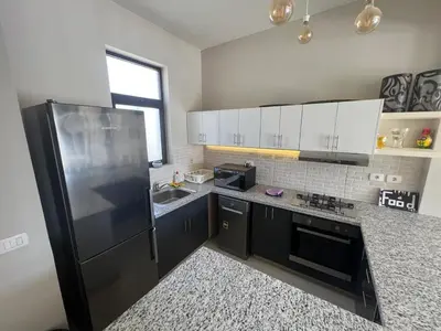 a kitchen with a black refrigerator and a sink at Tawila 3BR Family Townhouse • Lagoon Retreat Villa in Hurghada