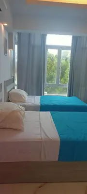 a bed in a bedroom with a window at شقه للايجار غرفه وصاله ومطبخ وحمام بالهضبه الغردقه in Hurghada