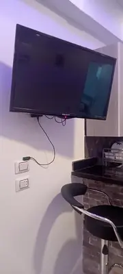 a flat screen tv hanging on a wall at شقه للايجار غرفه وصاله ومطبخ وحمام بالهضبه الغردقه in Hurghada