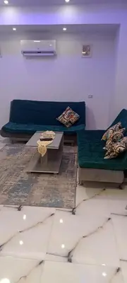 a living room with two couches and a table at شقه للايجار غرفه وصاله ومطبخ وحمام بالهضبه الغردقه in Hurghada
