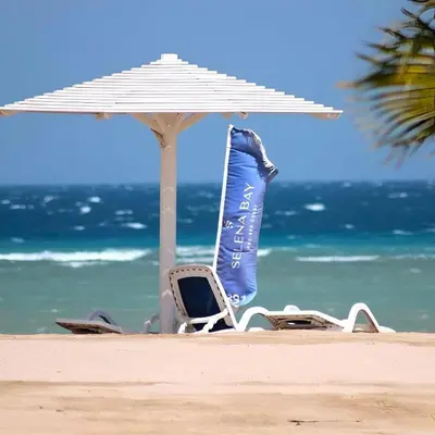 a chair and an umbrella on the beach at Selena Bay Boutique Hotel in Hurghada