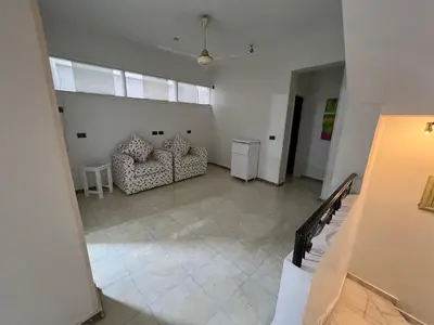 a living room with two chairs and a couch at Mohamed Home in Jazīrat al ‘Awwāmīyah