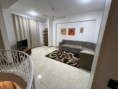 a living room with a couch and a tv at Mohamed Home in Jazīrat al ‘Awwāmīyah