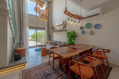 a living room with a table and chairs at Charming Jungle Home in Hurghada
