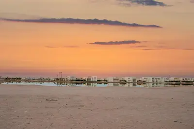 a view of the beach with buildings in the background at Charming Jungle Home in Hurghada