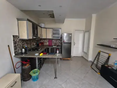 a kitchen with a stainless steel refrigerator in a room at Apartment in port Ghalib in Port Ghalib