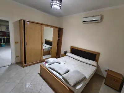 a bedroom with a bed with two pillows on it at Apartment in port Ghalib in Port Ghalib