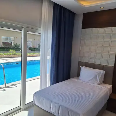 a bedroom with a bed and a view of a pool at Rewaya Majestic Resort in Hurghada