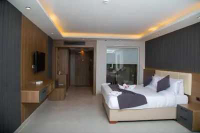 a bedroom with a large bed and a television at Rewaya Majestic Resort in Hurghada