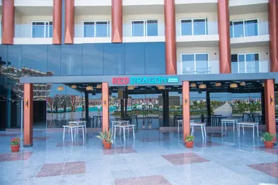 a building with tables and chairs in front of it at Rewaya Majestic Resort in Hurghada
