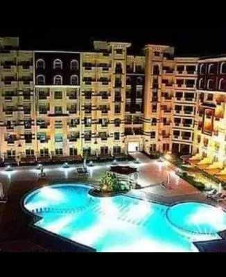 a large apartment building with a large swimming pool at Florenza khamsin Resort Hurghada Red Sea in Hurghada