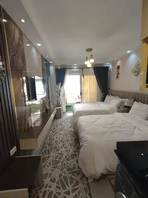a hotel room with two beds and a television at Florenza khamsin Resort Hurghada Red Sea in Hurghada