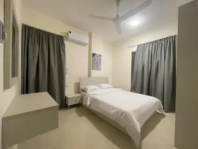 a bedroom with a white bed and a window at Bayt Hassan A7 - fabulous 2 bedrooms apartment in Hurghada