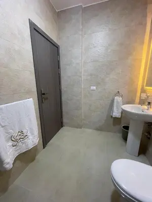 a bathroom with a toilet and a sink at Bayt Hassan A7 - fabulous 2 bedrooms apartment in Hurghada