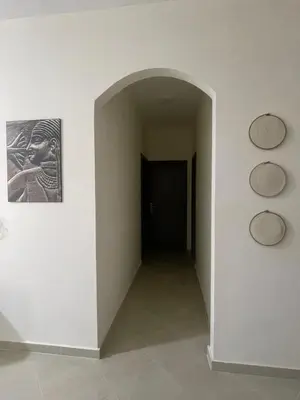 a hallway with a black door and a picture on the wall at Bayt Hassan A7 - fabulous 2 bedrooms apartment in Hurghada