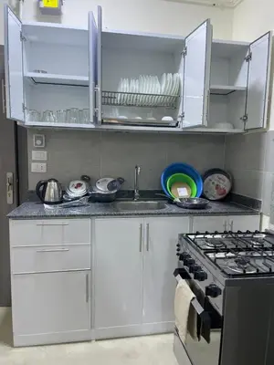 a kitchen with a sink and a stove top oven at Bayt Hassan A7 - fabulous 2 bedrooms apartment in Hurghada