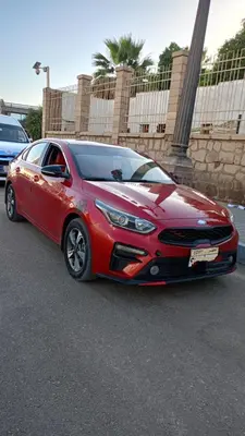 a red car parked in a parking lot at abu simbel and luxor trip in Jazīrat Suhayl