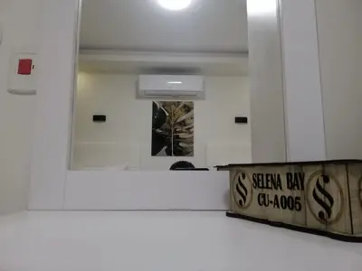 a mirror in a bathroom with a sign on the wall at Selena Bay Resort in Hurghada
