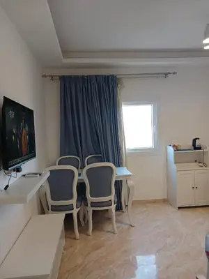 a room with a table and chairs and a window at Selena Bay Resort in Hurghada