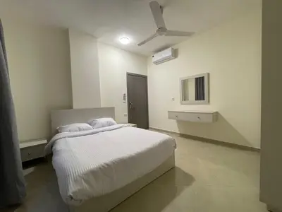 a bedroom with a bed and a ceiling fan at Bayt Hassan S6 - Cosy 1 bedroom apartment in Hurghada