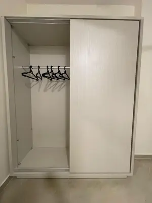a walk in closet with white doors and hangers at Bayt Hassan S6 - Cosy 1 bedroom apartment in Hurghada