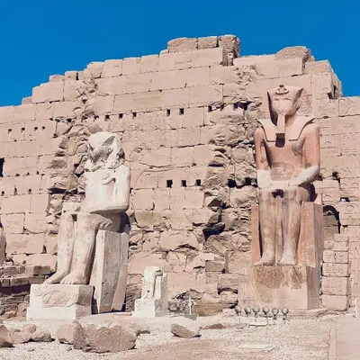 a building with two statues in front of it at Arabic Apartment in Hurghada