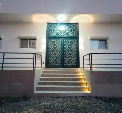 a green door on the side of a building with stairs at Ocean Apartment in Hurghada