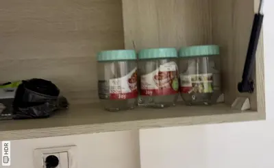 a shelf with four jars of food on it at فنادير باي in Hurghada