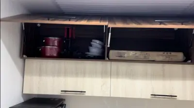 a wooden cabinet in a room with some dishes at فنادير باي in Hurghada