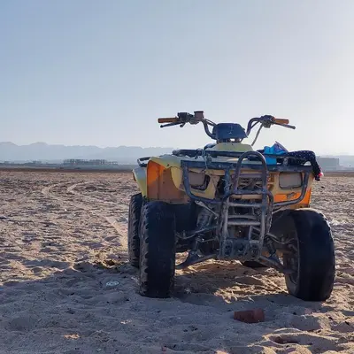 an atv parked on the sand in the desert at Boho Apartment in Hurghada