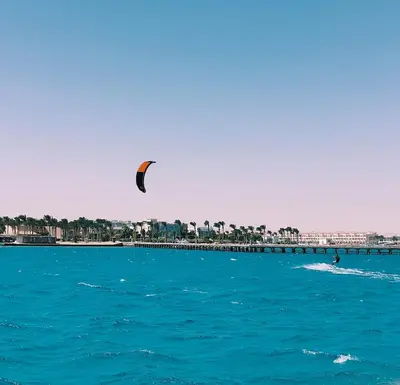 a kite flying over the water near a beach at Boho Apartment in Hurghada