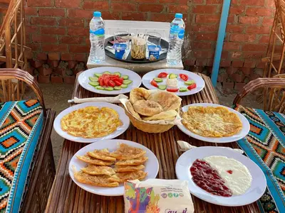 a table with plates of food on it at Garden view in Aswan