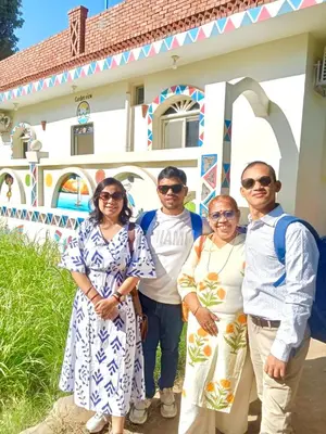 a group of people standing in front of a building at Garden view in Aswan