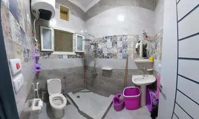 a bathroom with two toilets and a sink at Sila in Hurghada